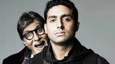 Amitabh Bachchan deeply engaged in a discussion with Abhishek Bachchan in a studio.